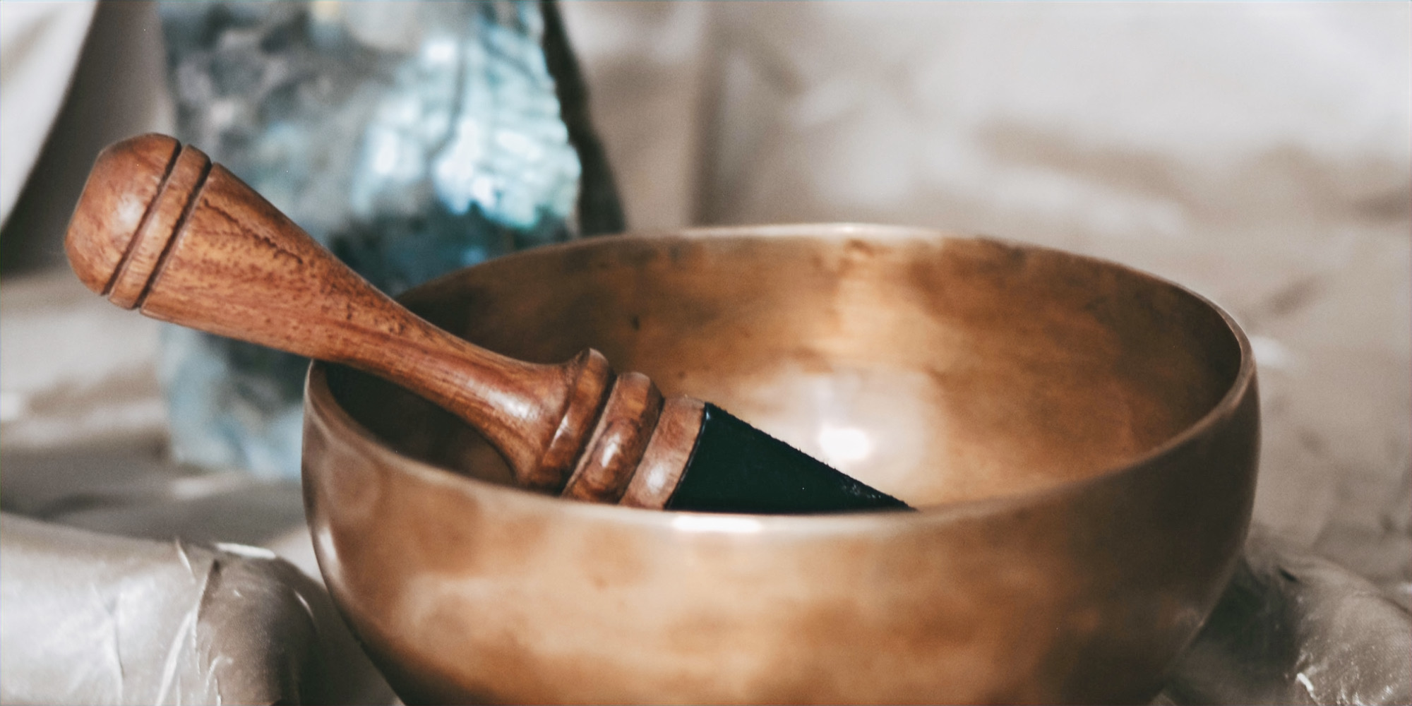 A Himalayan singing bowl with a wooden mallet